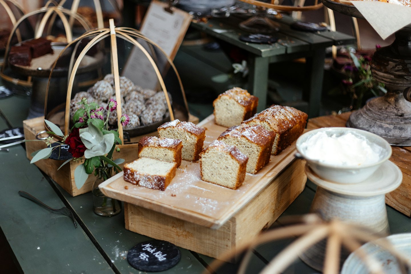 Freshly baked bread and cakes on a rustic bakery counter.